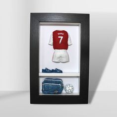 a soccer jersey and other items in a shadow box