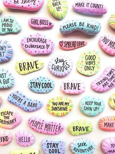 conversation rocks with words written on them in different colors and phrases, all over a white surface