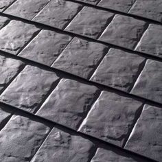 black and white photograph of the top of a roof made out of concrete blocks, with no visible shingles