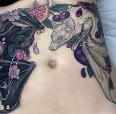 a close up of a woman's stomach with an animal tattoo on the side