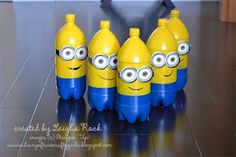 three plastic bottles with yellow and blue faces are sitting next to each other on the floor