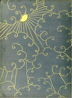 an old book with gold lines and swirls on the cover, in front of a dark background