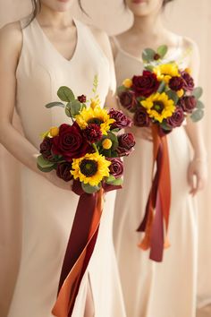 two bridesmaids holding bouquets of sunflowers and roses