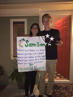 two people standing in front of a door holding a sign that says sam - tam