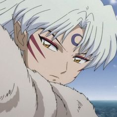 an anime character with white hair and red eyes is looking at the camera while standing in front of a body of water