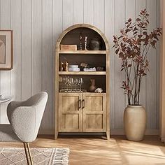 a white chair sitting in front of a wooden cabinet