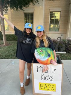 two women standing next to each other in front of a sign that says my little kicks bass