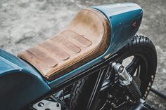 a close up of a motorcycle with a leather seat