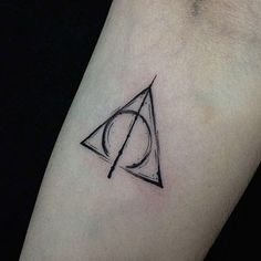 a harry potter symbol tattoo on the left forearm and right arm, with a black outline