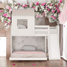 a white bunk bed with pink and white flowers