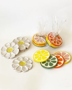 orange slices, lemons and grapefruit on a white surface