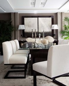 an image of a dining room with white chairs and a table in the middle of it