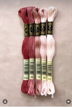 four skeins of yarn sitting next to each other