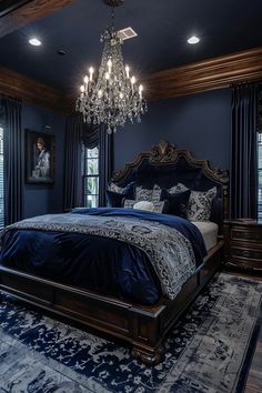 a large bedroom with blue walls and chandelier hanging from the ceiling, along with carpeted flooring