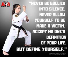 a woman in white karate outfit standing on one leg with her hand up and the words never be bullied into silence, never allow yourself to be