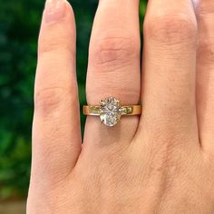 a woman's hand with a ring on it and a diamond in the middle