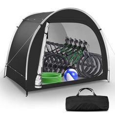 a tent with many bicycles in it and a bag on the ground next to it