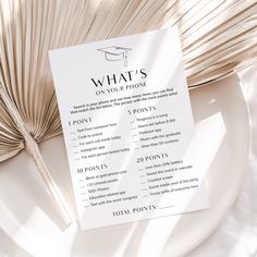 a white plate topped with a menu next to an open book