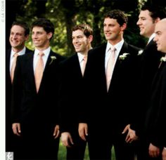 a group of men standing next to each other wearing suits and ties on their heads