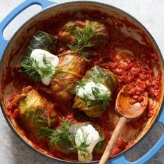 cabbage and artichokes with tomato sauce in a blue pot