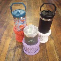 there are three different items on the table together, including a water bottle and cup holder