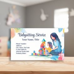 a babysitte service business card sitting on top of a wooden table