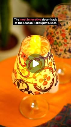 an orange table topped with two glasses filled with liquid