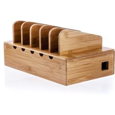 a wooden box with six compartments and four knives in it on a white background,