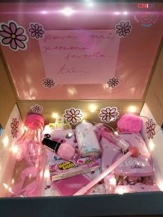 an open pink box with various items inside