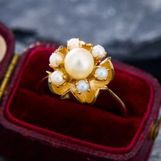 This artful ring features beautfully textured leaves that uphold a flower decorated with round Akoya pearls. The ring is crafted in sturdy 10k yellow gold and is currently a size 7.5. Gold Flower-shaped Pearl Ring For Wedding, Pearl Flower Ring, Akoya Pearls, Pearl Flower, Flower Ring, A Flower, Flower Decorations, Jewelry Rings, Yellow Gold