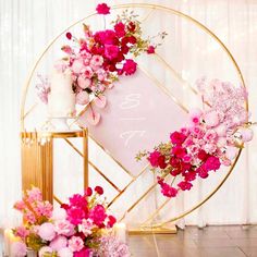 a table topped with pink flowers and candles next to a sign that says so sweet