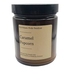 a jar of caramel popcorn sits on a white surface