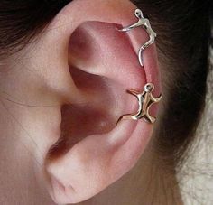 an ear piercing with three small stars on it