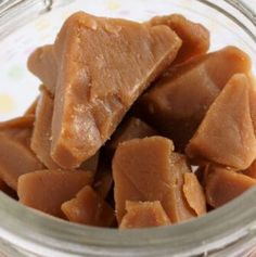 a glass bowl filled with pieces of peanut butter