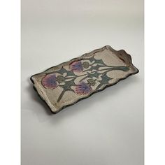 a decorative ceramic dish with flowers on it