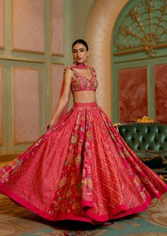 Featuring the blooming pink floral printed lehenga set with hand embroidered details and it is beautifully adorned using tassels, it is paired with hand highlighted blouse and net dupatta. Traditional Floral Print Sharara For Reception, Traditional Sharara With Floral Print For Receptions, Floral Print Traditional Wear For Diwali Reception, Pink Floral Print Palazzo Set For Wedding, Festive Floral Print Palazzo Set For Reception, Floral Print Sets For Wedding And Navratri, Navratri Wedding Floral Print Sets, Floral Print Wedding Sets For Navratri, Floral Wedding Sets For Navratri