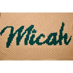 a crocheted afghan with the word mizzoh written in green on it