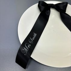 a white plate topped with a black ribbon