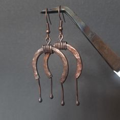 Hand-forged earrings infused with ancient symbolism. The horseshoe, a timeless emblem of luck, protection, and earth magic, is featured prominently. These pieces of jewelry evoke the spirit of a young world and the boundless freedom of the steppe. I feel it like this). Artisan Bronze Copper Hoop Earrings, Hand-forged Copper Earrings In Rust Color, Rustic Bronze Earrings, Unique Hand Forged Brown Earrings, Artisan Hand Forged Hoop Earrings, Hand Forged Rust-colored Unique Earrings, Hand Forged Bronze Rustic Earrings, Rustic Hand Forged Earrings, Unique Crescent Shaped Copper Jewelry