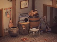 a teddy bear sitting on the floor in front of a wooden barrel and other items