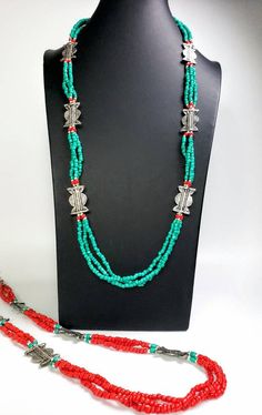 Add color and pizzazz to any outfit with this beautiful hand crafted Tibetan coral color multi strand bead necklace with silver tone amulets. The faux turquoise accents makes the amulets pop! A simple but very striking necklace! Perfect for a beach vacation with a carefree white dress or in the city to dress up jeans. Makes a beautiful gift! Twist the necklace for a totally different look! Excellent quality and craftsmanship. - 3 strands of irregular beads - bright red/orange color - silvertone Traditional Handmade Double Strand Beaded Necklaces, Spiritual Multi-strand Jewelry With Large Beads, Traditional Double Strand Beads For Gift, Traditional Handmade Double Strand Beaded Necklace, Traditional Double Strand Beaded Jewelry, Traditional Multi-strand Jewelry With Large Beads, Bohemian Multi-strand Jewelry For Festivals, Traditional Multi-strand Beads For Jewelry Making, Silver Multi-strand Bohemian Beads