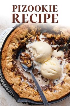 a pie with ice cream on top and spoons in the bowl next to it