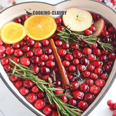 cranberries and oranges in a heart shaped dish