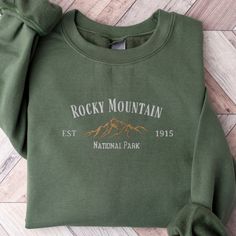 the rocky mountain sweatshirt is green with white lettering