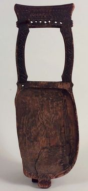 an old wooden object with holes in the back and sides, on a white background