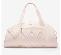 This spacious duffel bag from Nike is perfect for all your travel, casual, and work needs. The bag is made of 100% polyester exterior material and features a solid dusty pink pattern with silver, blush, light pink, baby pink, and rose character accents. It has a zip closure and comes with a detachable shoulder strap for added convenience. The bag is large in size, measuring 21 inches in width and 15 inches in height, and has a brown polyester lining. It also includes a pouch, coin purse, key holder, and detachable strap as accessories. The Nike One Club Women's Training Duffel Bag is a must-have for any sports enthusiast and is available for purchase now. Cheer Basketball, Nike Shoulder Bag, Gym Bags For Women, Cute Gym Bag, Nike Dance, Volleyball Bag, Basketball Bag, Nike Pro Leggings, Training Bags