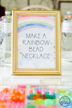 there is a sign that says make a rainbow bead necklace in front of some candy