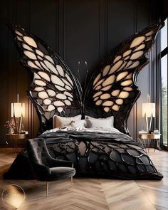 a large butterfly shaped bed sitting on top of a wooden floor