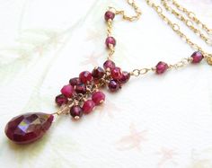 Gorgeous natural ruby teardrop gemstone pendant is accented with red ruby and garnets. Small finely faceted ruby gemstones dot the chain and creates a lovely artisan style necklace. Perfect gift for women who love ruby gemstones and artisan jewelry. A thoughtful necklace gift for a woman born in July since ruby is her birthstone. Necklace Details: - Fine Heart jewelry is always handmade and custom fitted for you - Choose your necklace length via the drop down menu --- A standard necklace is 18 i Red Ruby Briolette Jewelry, Ruby Briolette Gemstone Jewelry, Ruby Necklace Gold, July Birthstone Jewelry, Ruby Necklace, Ruby Earrings, Garnet Stone, Wedding Jewellery Necklace, July Birthstone