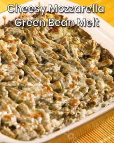 cheesy mozzarella green bean melt in a white casserole dish